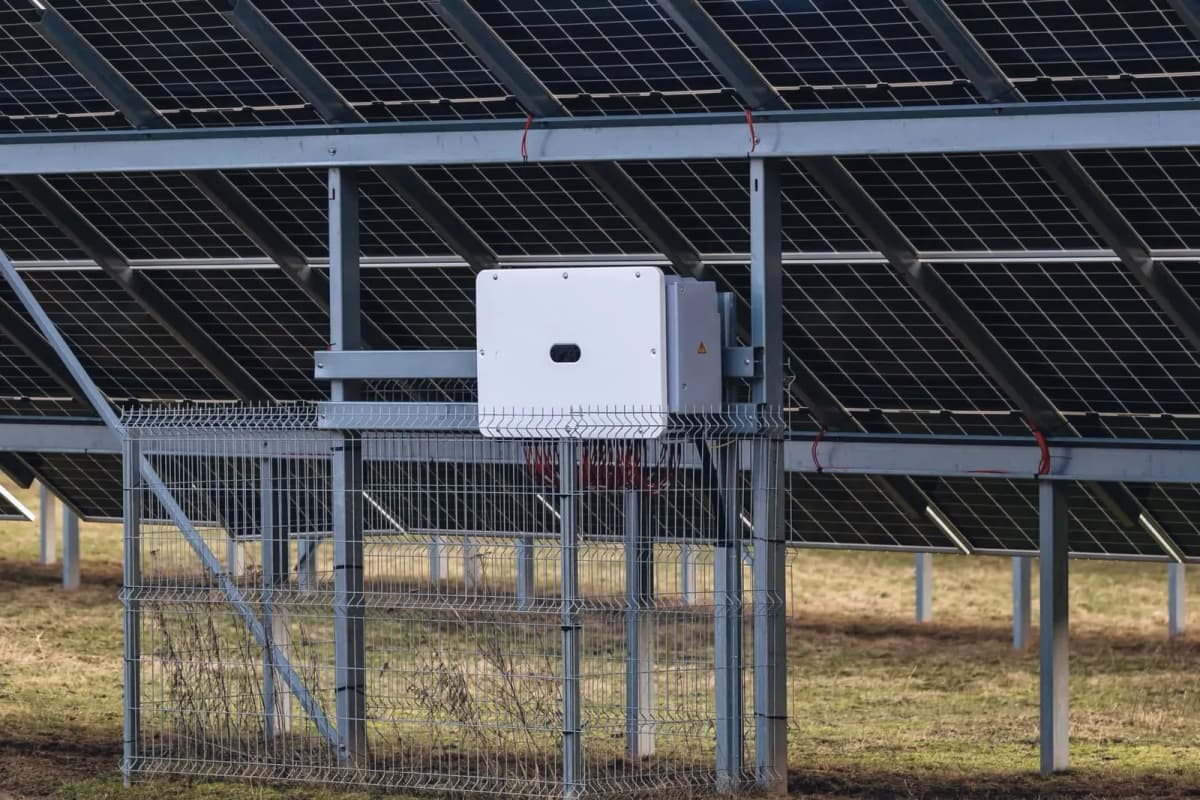 Inverter under a row of solar panels in a field
